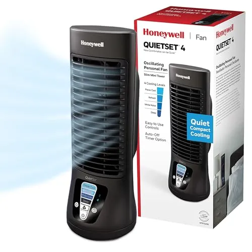Compact desk fan featuring curved blades and a precision motor, positioned on a workspace desk.
