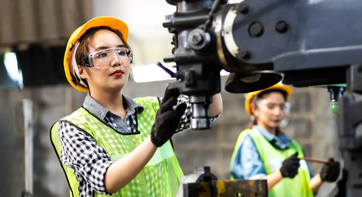 Automated machinery and digital interface displays in a modern manufacturing facility.