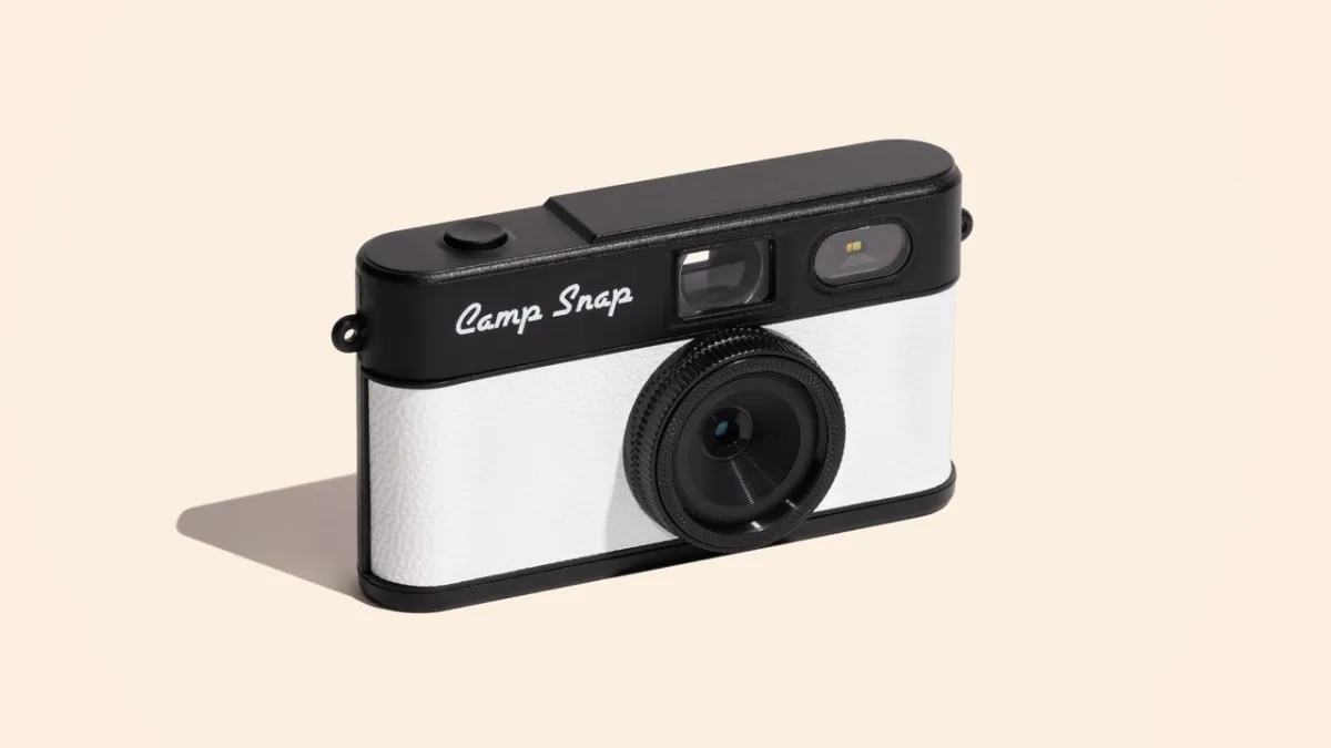 The Camp Snap 2 screen-free digital camera features a compact body, fixed lens, and dedicated filter toggle button.