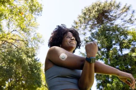 A person exercises at home while a smartphone app tracks joint angles and displays real-time form corrections.