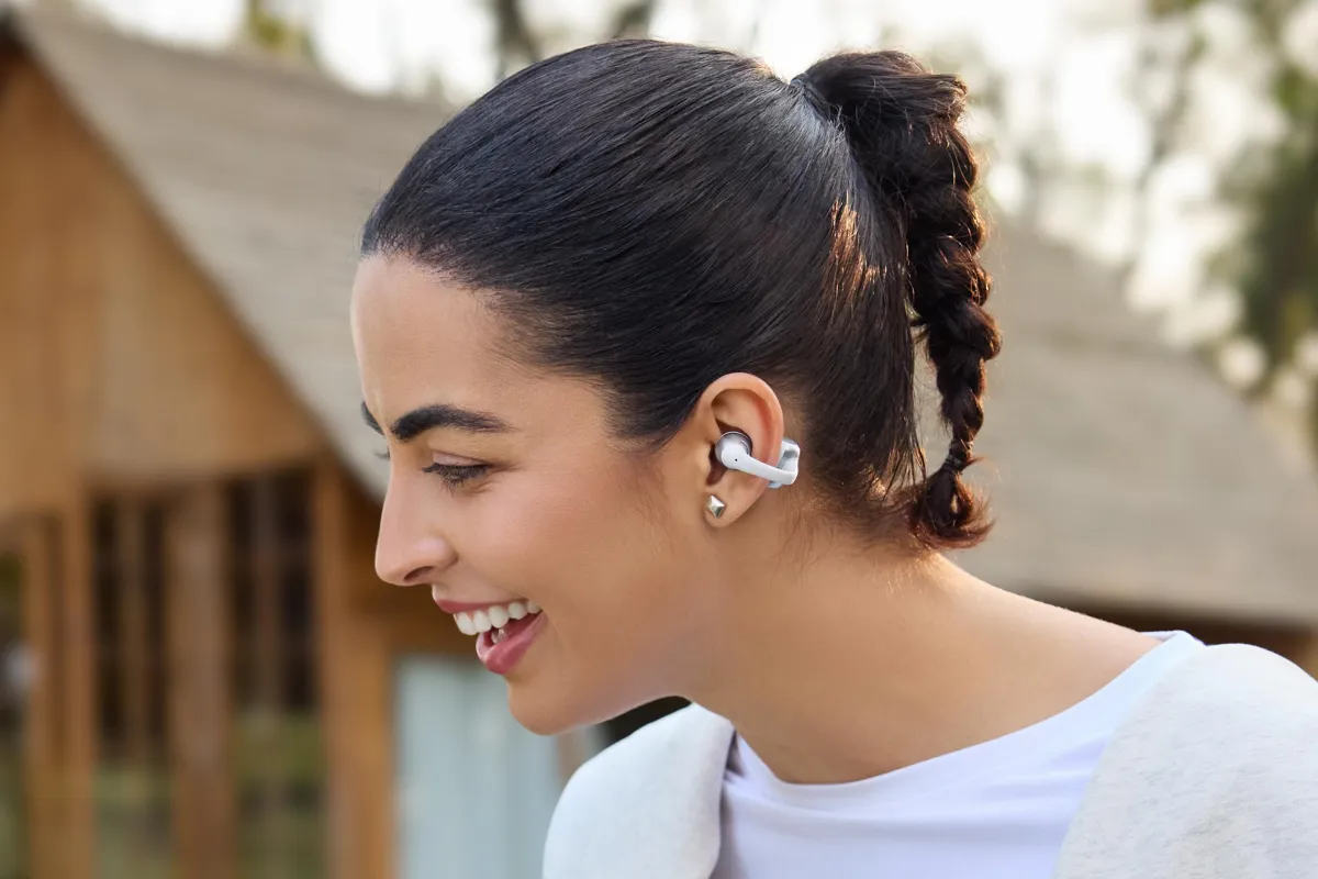 Shokz OpenDots Air and OpenDots 2 open-ear clip-on earbuds displayed side by side.
