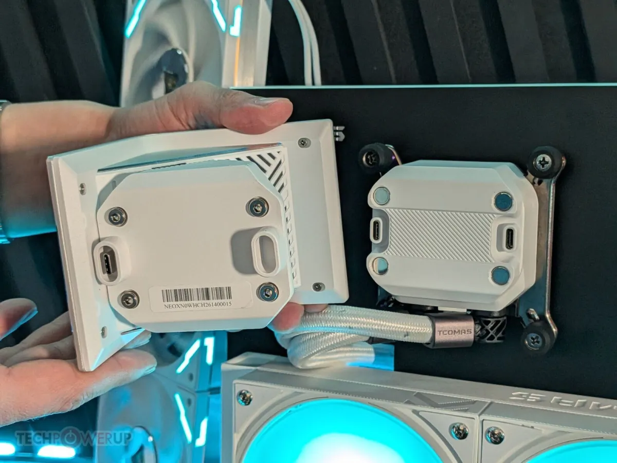 Cube-shaped EXIT D3 Pro AIO cooler with three integrated displays arranged along its inner half.