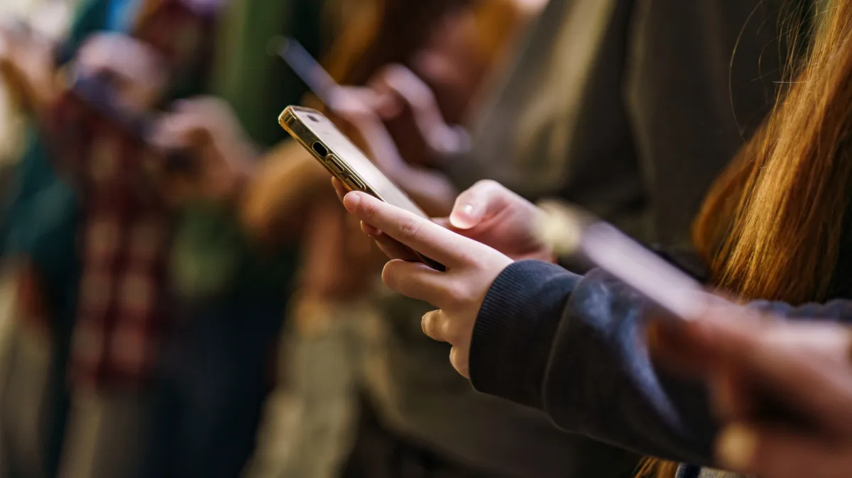 A smartphone displaying social media applications with a prohibition symbol