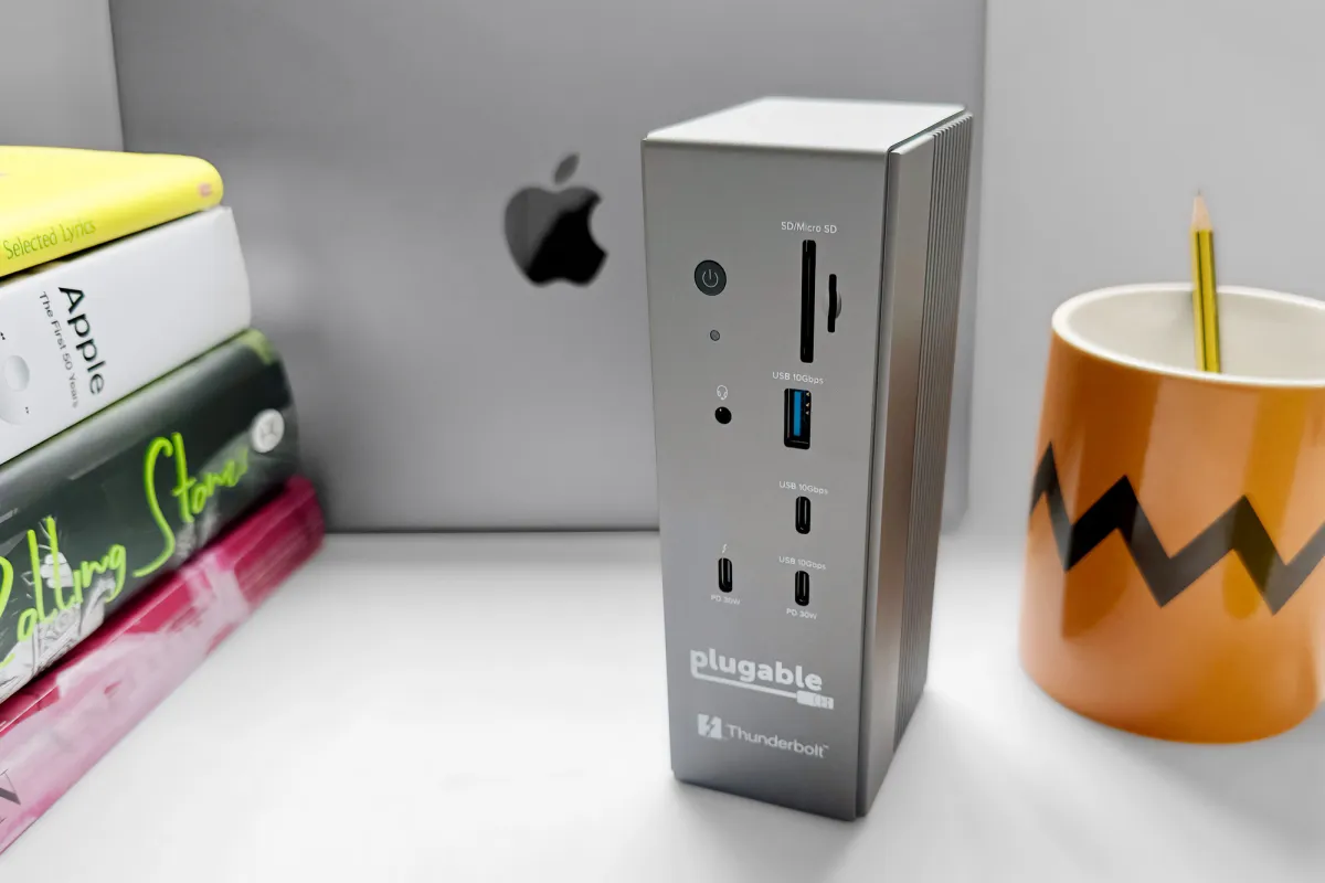 The Plugable Thunderbolt 5 docking station features dual HDMI ports, multiple USB connectors, and a front card reader.
