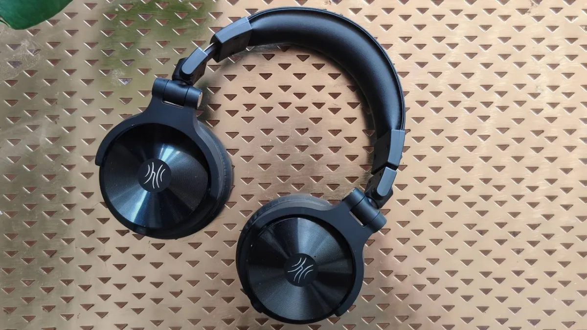 OneOdio Studio Max 2 over-ear headphones displayed with their wireless monitoring transmitter
