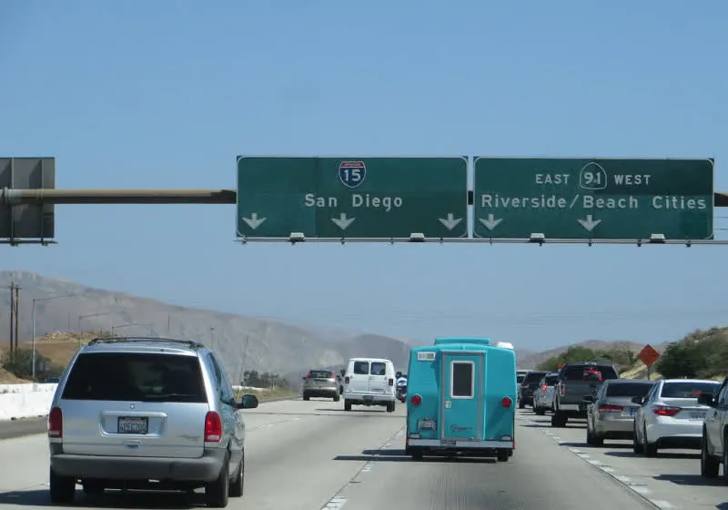 A ramp meter traffic signal regulates vehicle entry onto Interstate 15 in Riverside County.