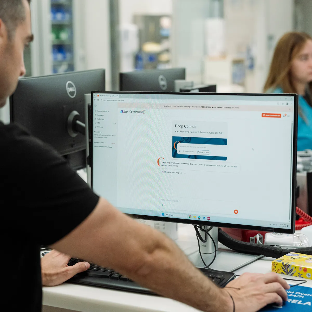 A doctor consults an artificial intelligence platform to answer complex clinical questions.