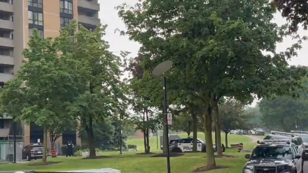 Toronto police officers at a residential property during a warrant execution