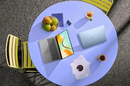 Asus Zenbook 14 laptop shown in Arctic Blue, Komodo Coral, and Zabriskie Beige finishes.