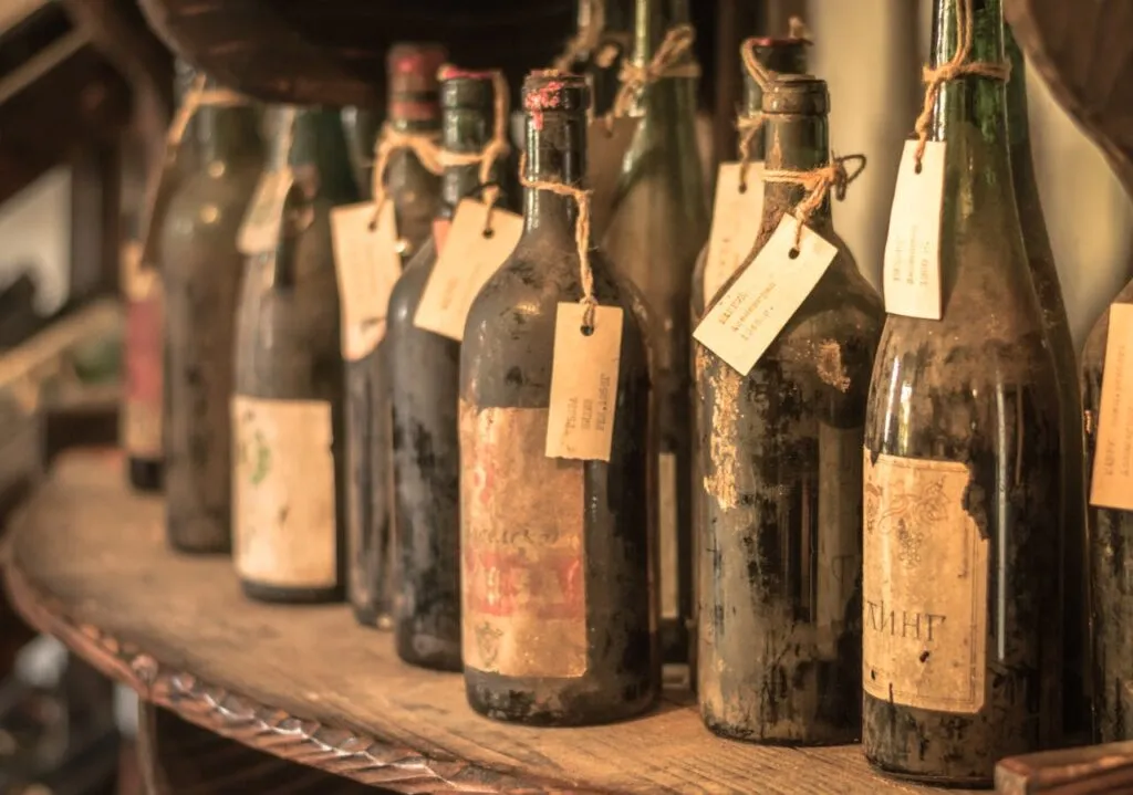 A historic Georgian wine cellar displays rows of rare bottles dating back over two centuries.