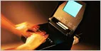 A court reporter operates a stenotype machine to capture testimony and gestures during a legal proceeding.