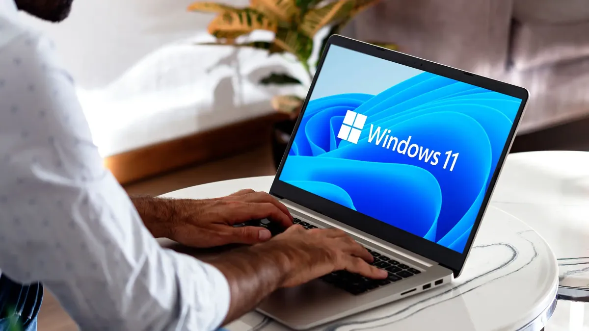 A monitor displays the Windows 11 BitLocker recovery screen after a failed EFI partition update.