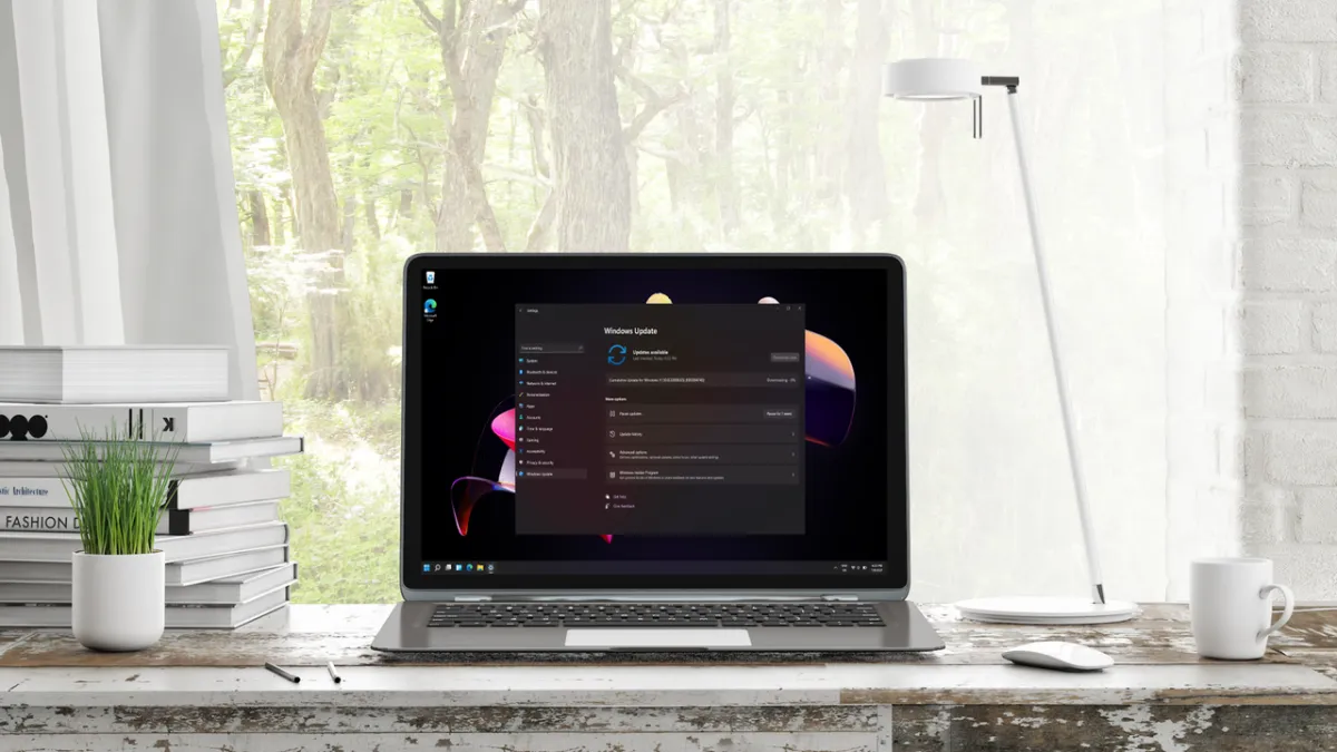 A computer screen displays the Windows 11 update settings page with a progress bar.