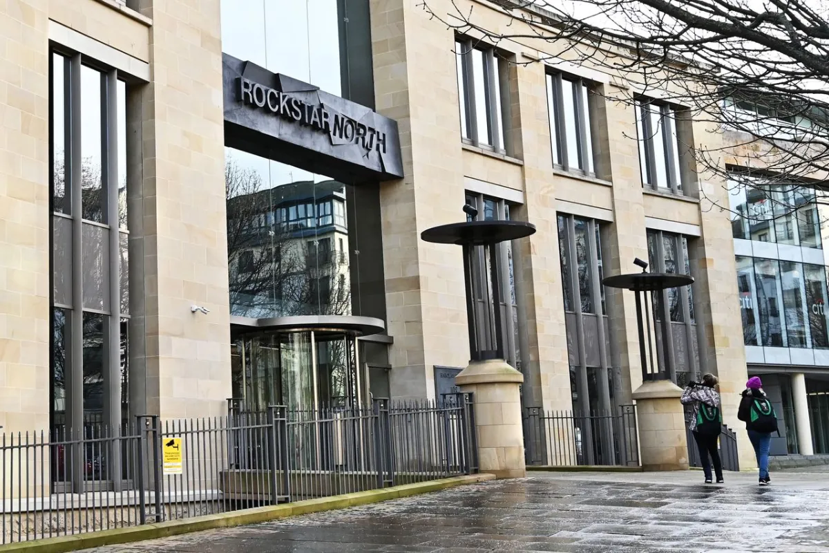 A person records audio and environmental data outside Rockstar North headquarters.