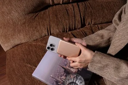 A compact portable power bank featuring magnetic wireless charging and a slim profile for mobile use.