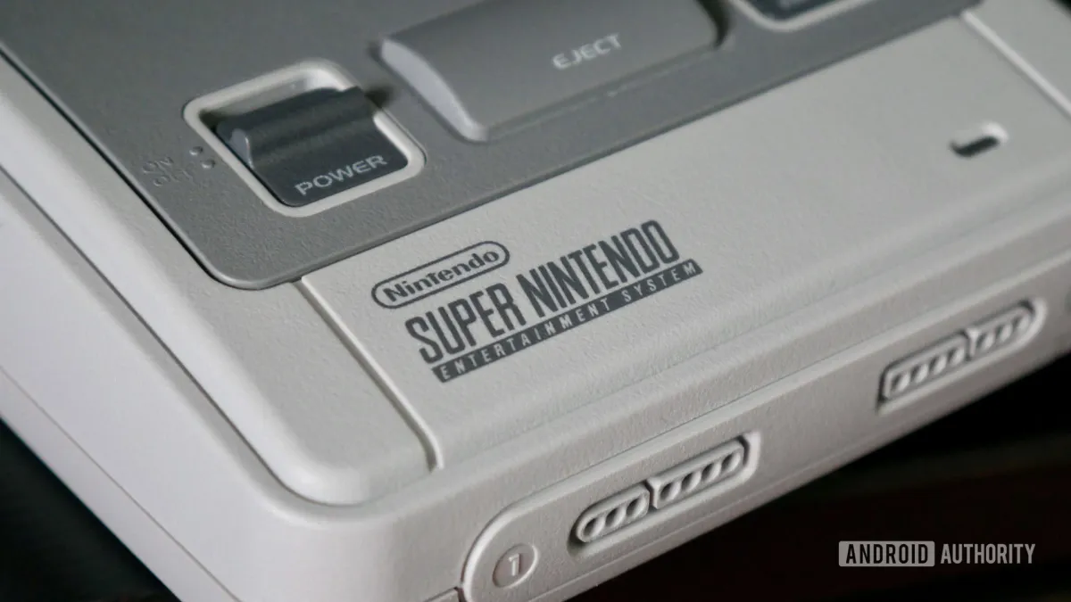 Delta emulator on iPhone with SN Operator hardware adapter connected to a physical Super Nintendo cartridge.