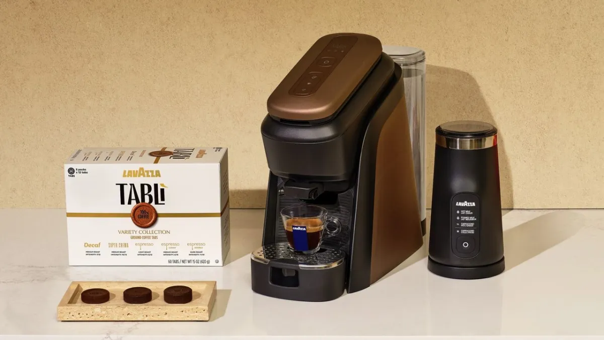 Lavazza Tabli compressed coffee tablets and brewing hardware are arranged on a clean surface.
