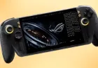 A translucent black handheld console shows visible golden structural elements and an OLED screen alongside AR glasses.