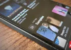 The Android screen displays the YouTube Music app interface for the artist blocking feature.