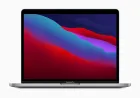 A refurbished 13-inch MacBook Pro with 16GB RAM and a 512GB SSD rests on a desk.