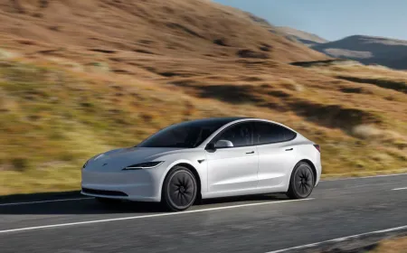 A Tesla Model 3 sedan is parked on a Canadian street, reflecting recent pricing adjustments for the Shanghai-built vehicle.