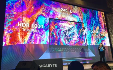 Gigabyte AORUS Master 16 gaming laptop open on a desk, showcasing its sixteen inch QHD OLED display.