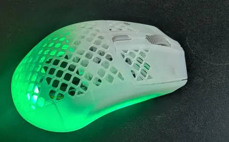 SteelSeries Aerox 3 Wireless Gen 2 mouse with honeycomb chassis and wireless receiver.