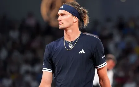 Tennis athletes compete on a red clay court during the 2026 French Open men's final match.