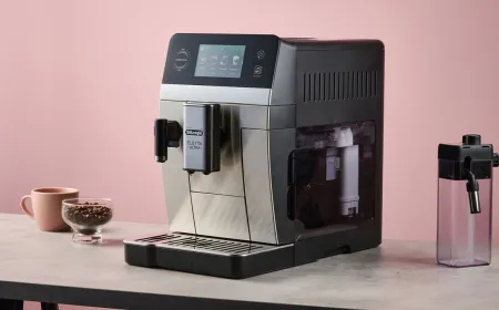 A De'Longhi bean-to-cup coffee machine brews hot and cold beverages on a kitchen counter.