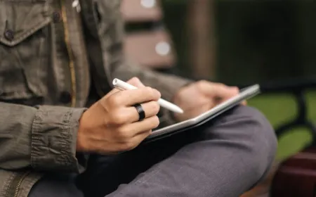 A 14-inch shipping box sits next to a 9-inch tablet to demonstrate the packaging size discrepancy.
