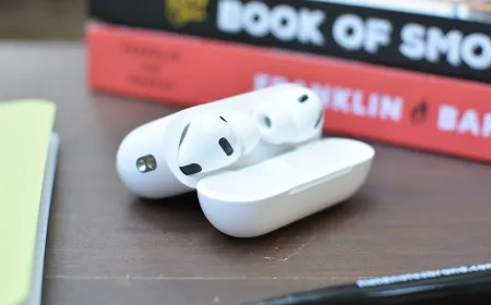 AirPods rest beside an iPhone screen displaying the Camera Remote settings menu.