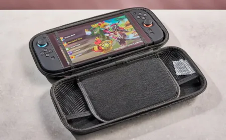A Nintendo Switch 2 console rests on a flat surface alongside its Joy-Con controllers and a game cartridge.
