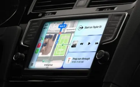 The updated CarPlay interface displays new media controls, navigation maps, and voice assistant features.