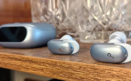The Anker Soundcore Liberty 5 Pro earbuds rest beside their charging case on a clean surface.