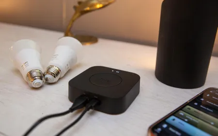 The Philips Hue Bridge Pro smart lighting hub shows status LEDs and network ports.