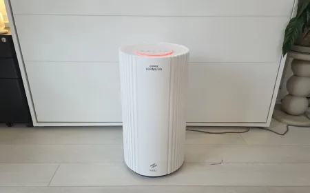 The Coway Airmega 350 air purifier features a white casing, a circular control panel, and a central air quality sensor.