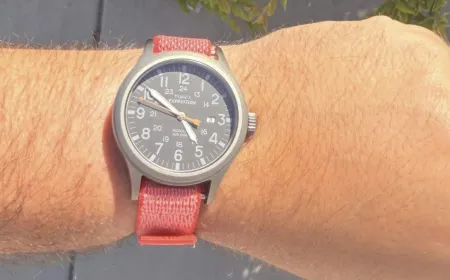 A modified Fitbit Air tracker displays time via a traditional watch face attached to its fitness band.
