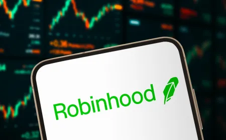 A computer screen displays the SpaceX and Robinhood logos alongside financial charts.