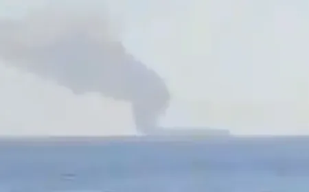 A commercial tanker emitting thick smoke off the Oman coast near the Strait of Hormuz.