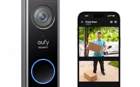 A modern video doorbell mounted on a front door frame, showing its camera lens and motion sensor.