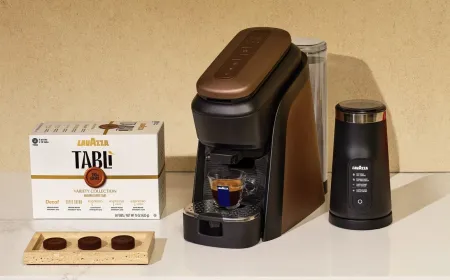 Lavazza Tabli compressed coffee tablets and brewing hardware are arranged on a clean surface.