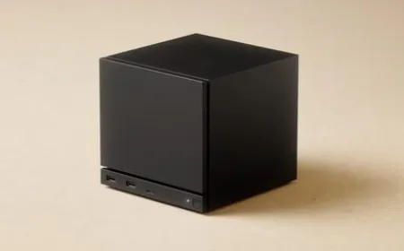 The Valve Steam Machine review unit is shown alongside its dedicated controller and mounting accessories.