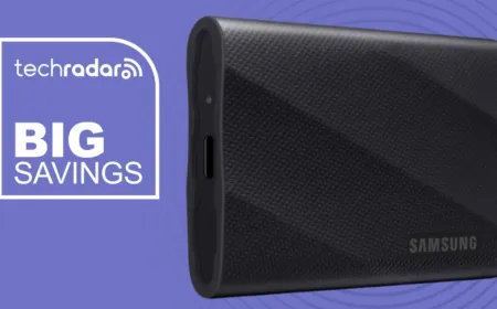 The Samsung T9 portable SSD rests on a white surface alongside a USB-C cable.