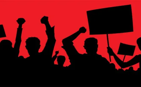 Protesters gather near a large datacenter facility surrounded by power grid infrastructure