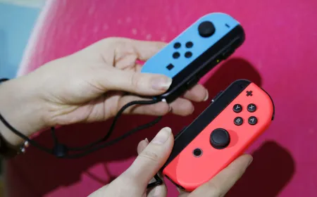 A Nintendo Switch Joy-Con controller is pictured alongside official documentation regarding the stick drift penalty.