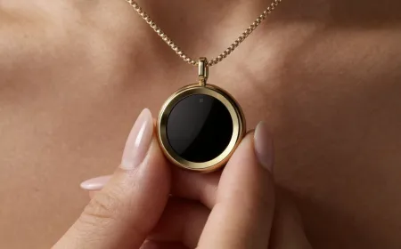 The Gem necklace is worn on a model to display its compact UV sensor and companion app interface for tracking sun exposure.