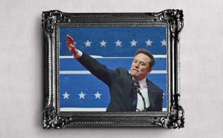 Elon Musk stands beside a SpaceX rocket during a presentation.