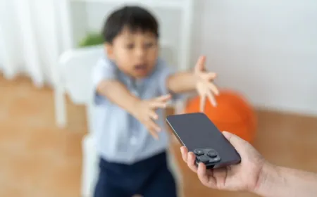 A child interacts with a digital tablet in a home setting.