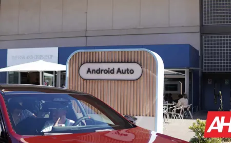 A smartphone displays the Android Auto interface while connected to a vehicle dashboard