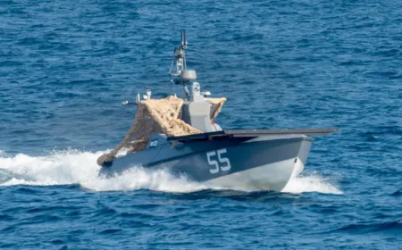 Uncrewed drone boat recovering a downed Apache helicopter crew near the Strait of Hormuz.